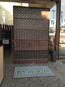 giant brown rotating door at entrance of hotel maya
