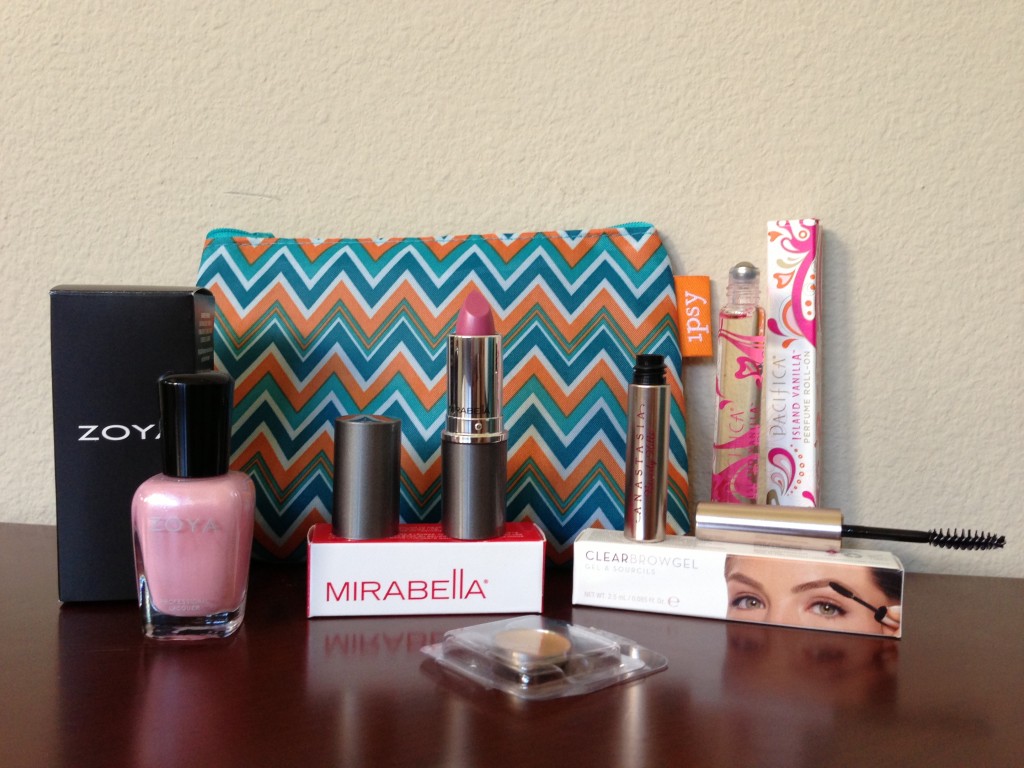 ipsy may 2013 bag items with boxes including zoya gie gie nail polish, yaby honey concealer, mirabella daydream lipstick, anastasia clear eyebrow gel, and pacifiica island vanilla perfume roller