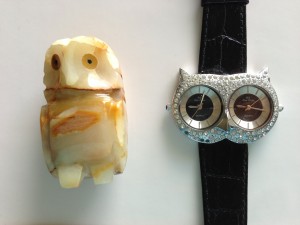 small brown stone owl sculpture and owl face watch