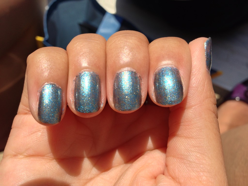zoya crystal nail polish blue with gold flecks on fingernails in sunshine