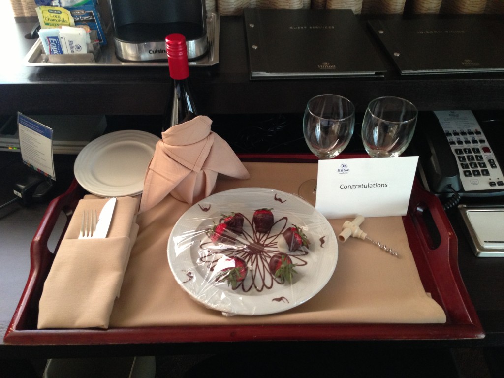 tray with congratulations note, bottle of pinot noir, and plate of chocolate-covered strawberries