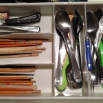 partial look at drawer filled with utensils for eating