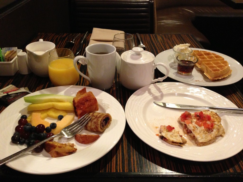 hilton anaheim hot breakfast with fruit, omelet, waffles, orange juice, tea, and more
