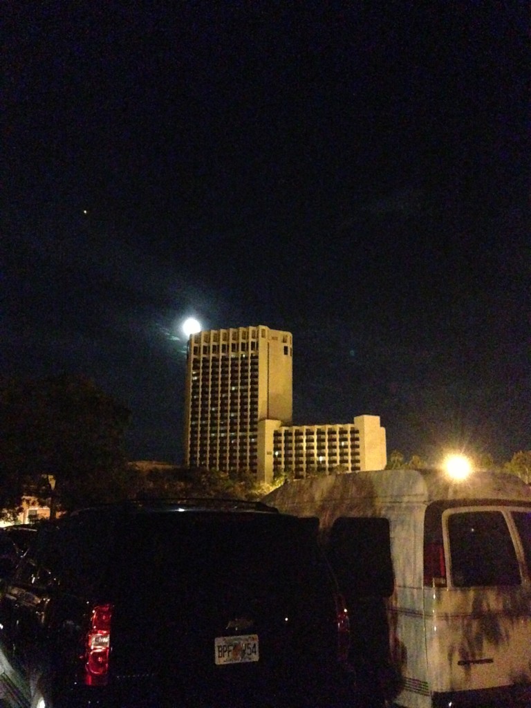 bright moon over hotel in distance