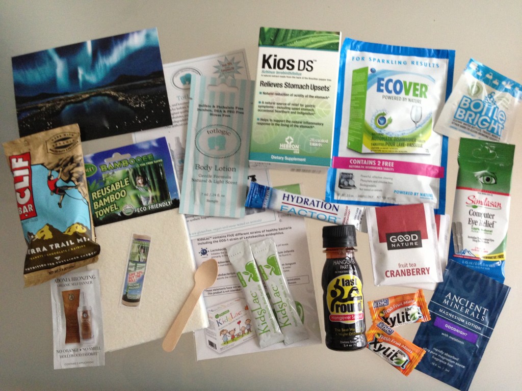 conscious box july contents including clif bar, adonia self-tanner, bambooee towel, totlogic lotion, kidslac probiotics, eco-gecko spoon, kios stomach relief, ecover dishwasher tablets, mdm hydration factor, last round hangover support, good nature tea, epic dental mints, clean ethics bottle bright cleaner, similasan eye drops, ancient minerals lotion