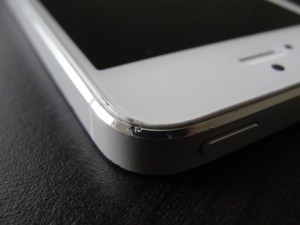 corner of white iphone 5 with scratches and dents on corner