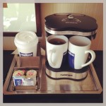 coffee/tea maker and mugs in hotel room