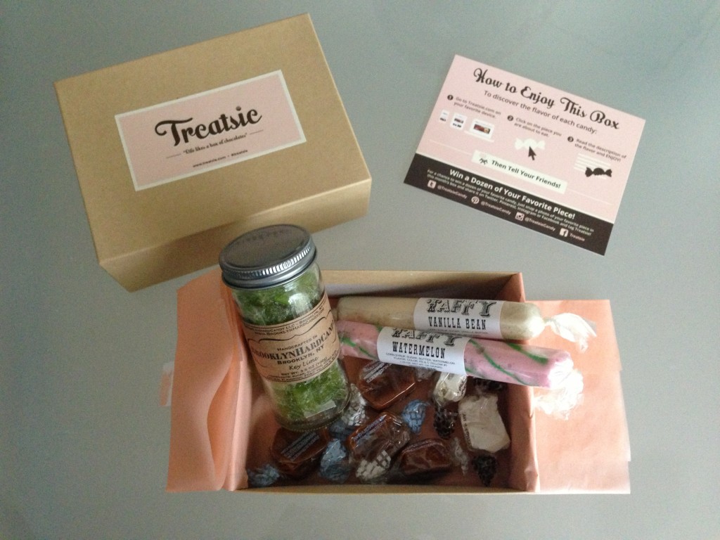 treatsie july box contents with brooklyn hard candy jar, mehlenbacher's taffy sticks, and avenue sweets caramels and nougats