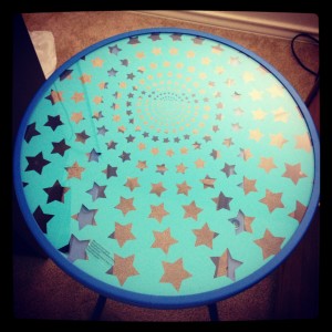 small round glass table with blue background and clear star pattern