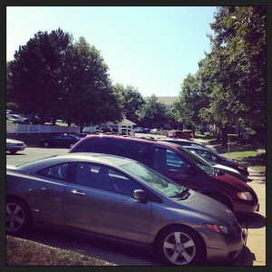 parking area filled with cars in afternoon