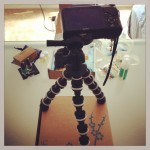 camera using gorilla style tripod on yuzen box to film videos