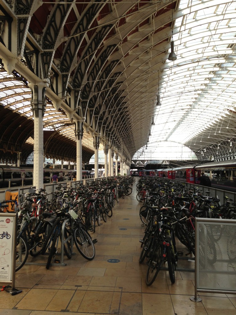 bike parking area with dozens of bikes inside victoria station in london