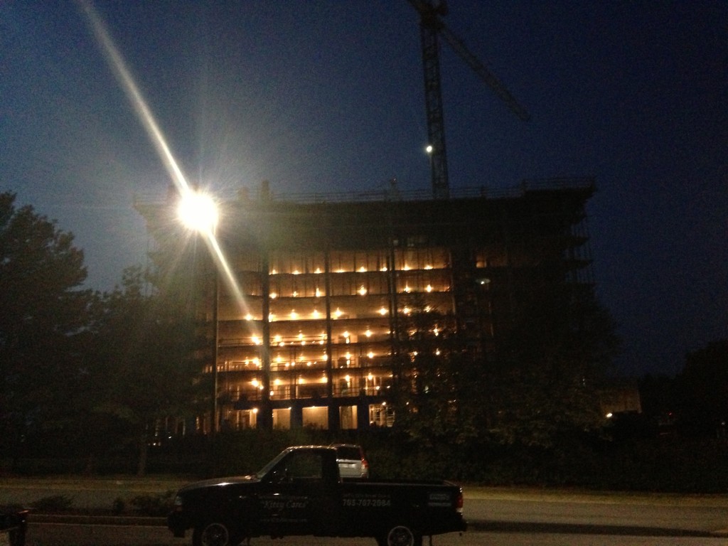 building being contructed lit up at night