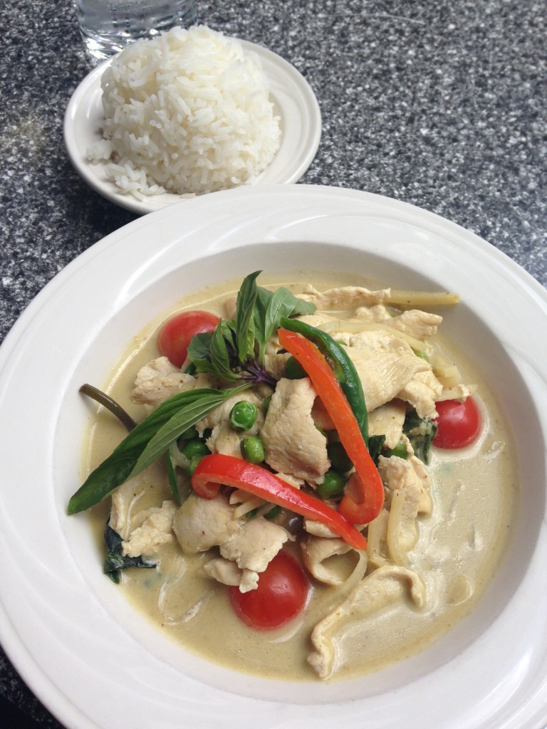 green curry chicken dish with bowl of jasmine rice at busara thai restaurant
