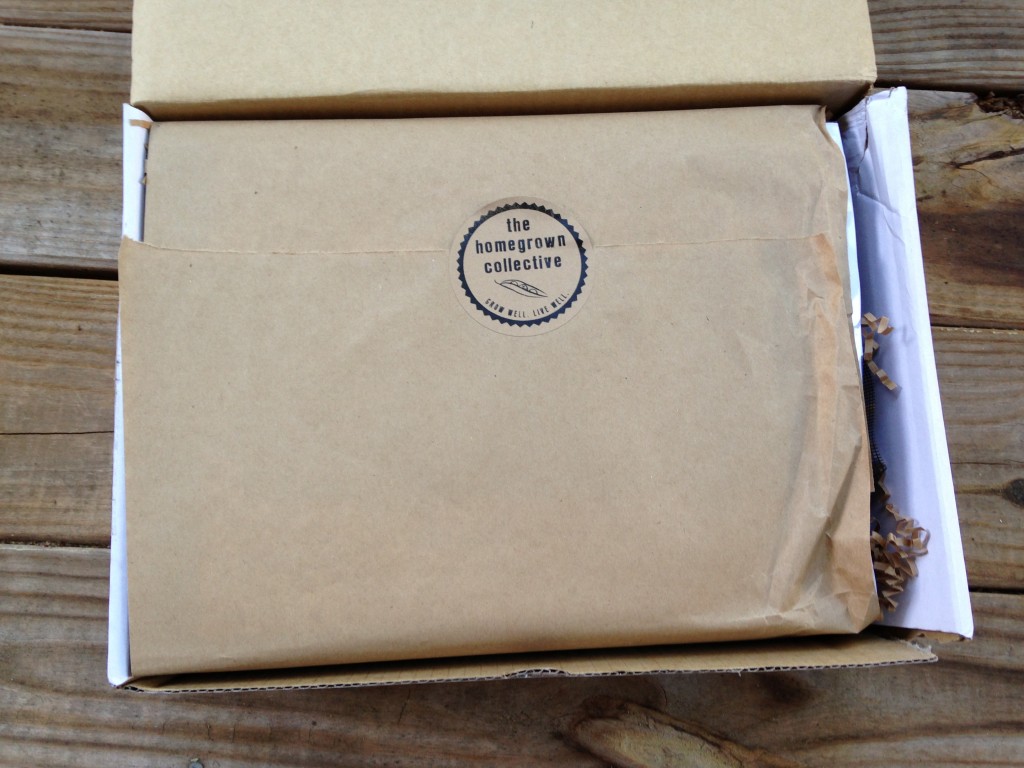 inside of homegrown collective box with the homegrown collective sticker on brown paper wrapping