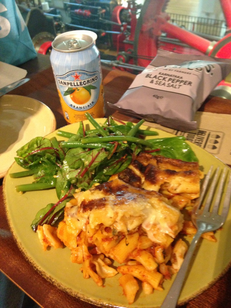 pasta bake and salad with san pellegrino orange soda drink and black pepper and sea salt chips