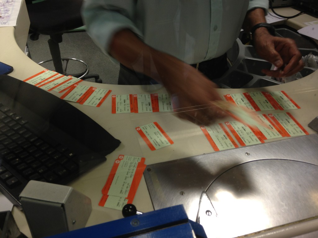 ton of train tickets laid out on table as they are printed out