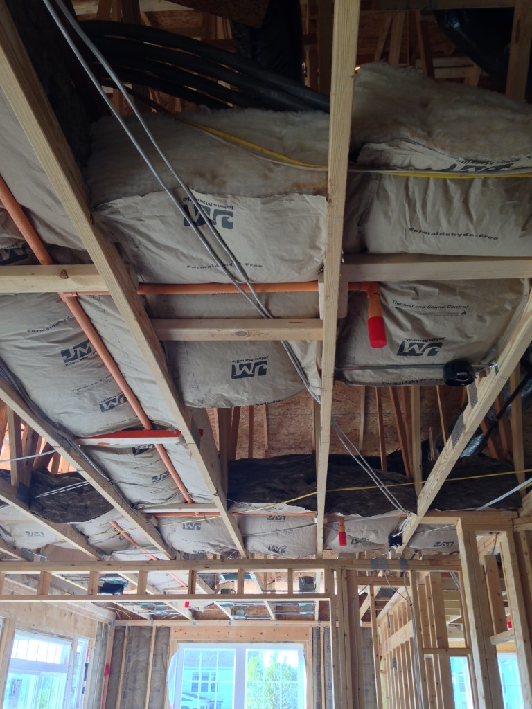 large blocks of insulation sitting on wooden beams for future ceiling
