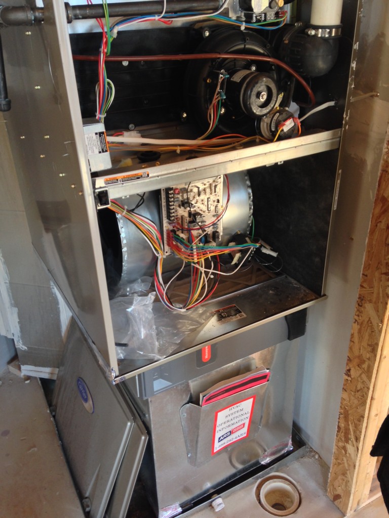open hvac box with wiring and piping