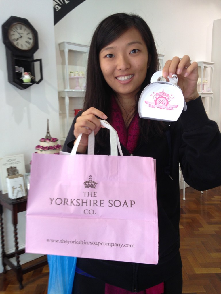 holding up yorkshire soap co shopping bag and cute paper box