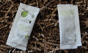 collage of 100% pure green apple nourishing body cream sample packet included in april 2013 blissmobox