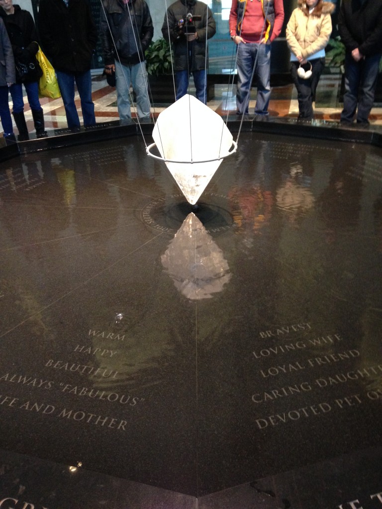 11 tears memorial in american express tower with large crystal suspended above pool of water