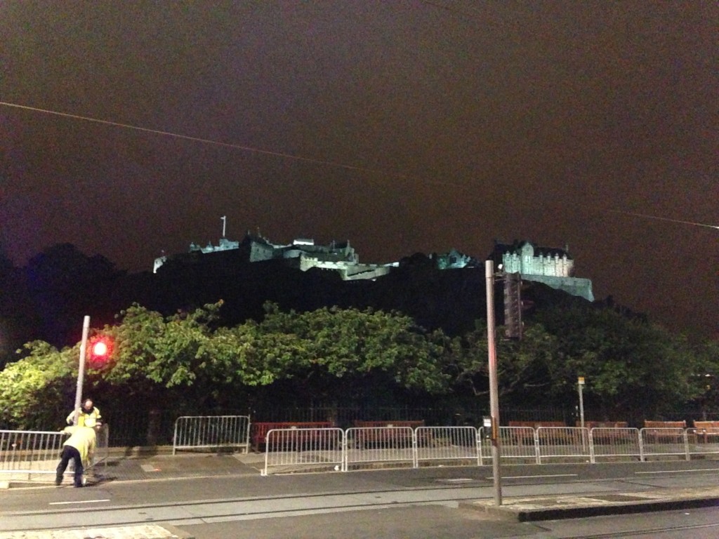 view of edinburgh castle at night from princes street