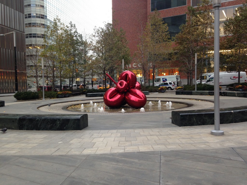 giant red balloon sculpture in center of fountain area in new york city