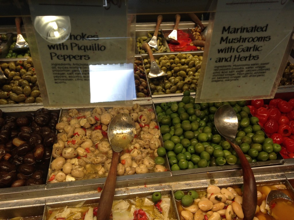 marinated mushrooms with garlic and herbs at olive bar in whole foods