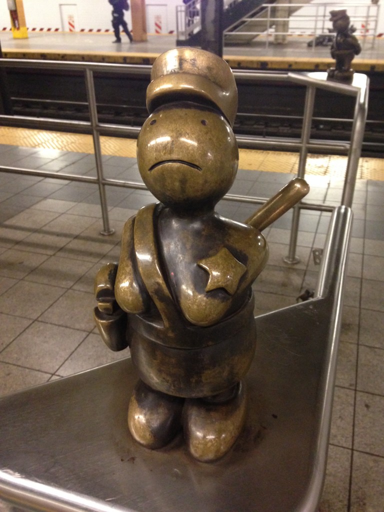 metal cartoonish statue in subway station