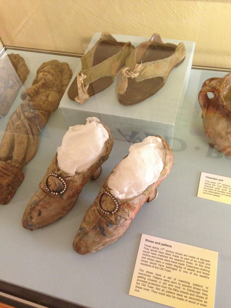 pairs of old shoes on display at museum of edinburgh