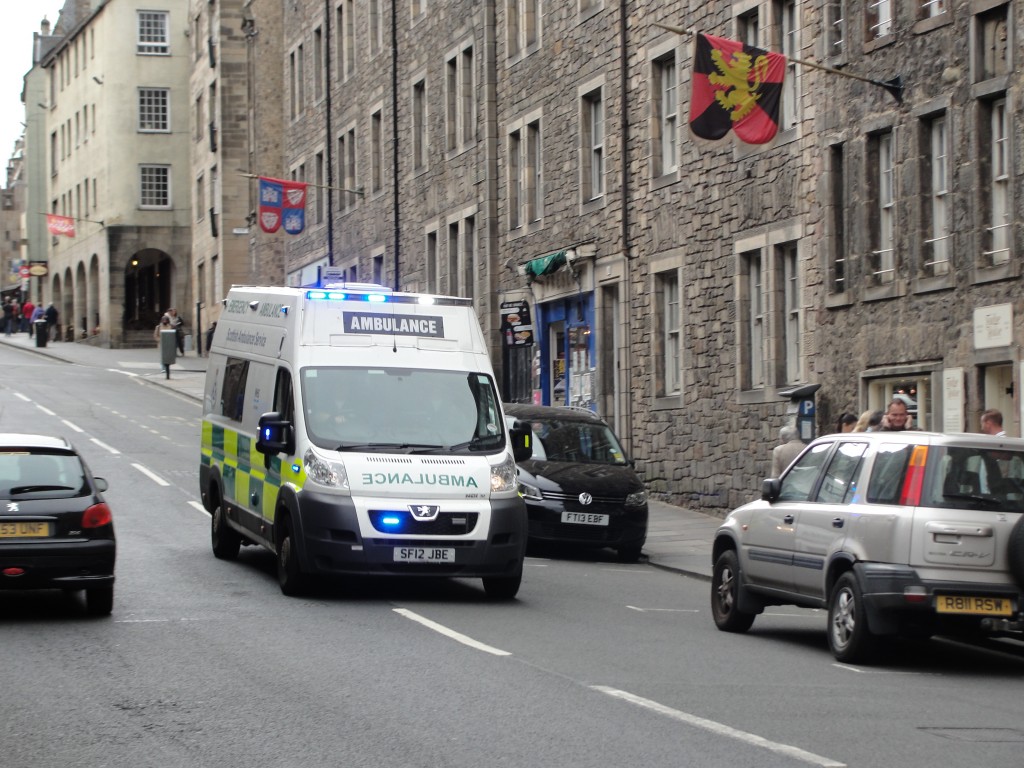 scottish ambulance driving down road in edinburgh