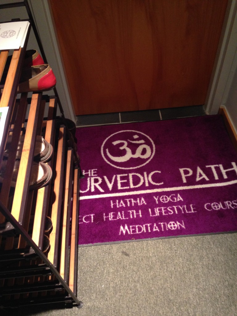 floor of the ayurvedic path entrance with welcome mat and shoe rack