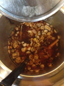 large tub of hot and sour soup with a ton of mushrooms