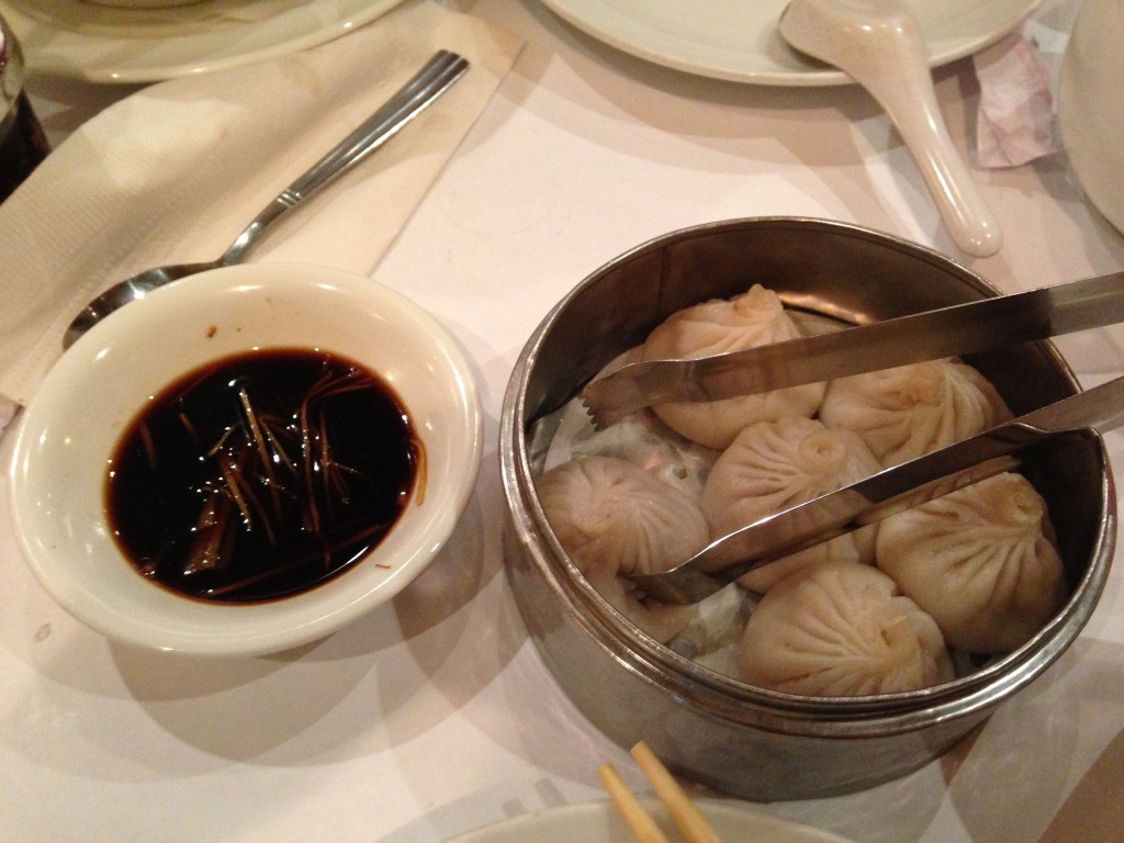 small rack of six xiao long bao juicy pork dumplings with vinegar sauce