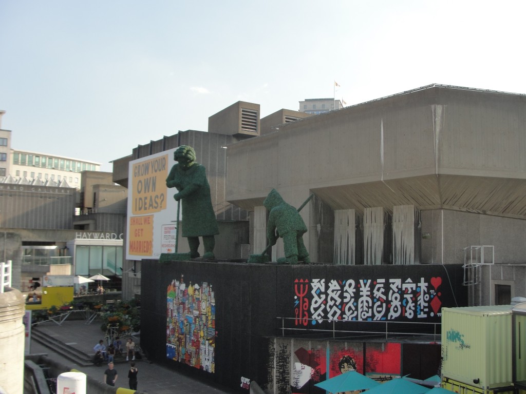 large statues and mural by waterloo bridge in london