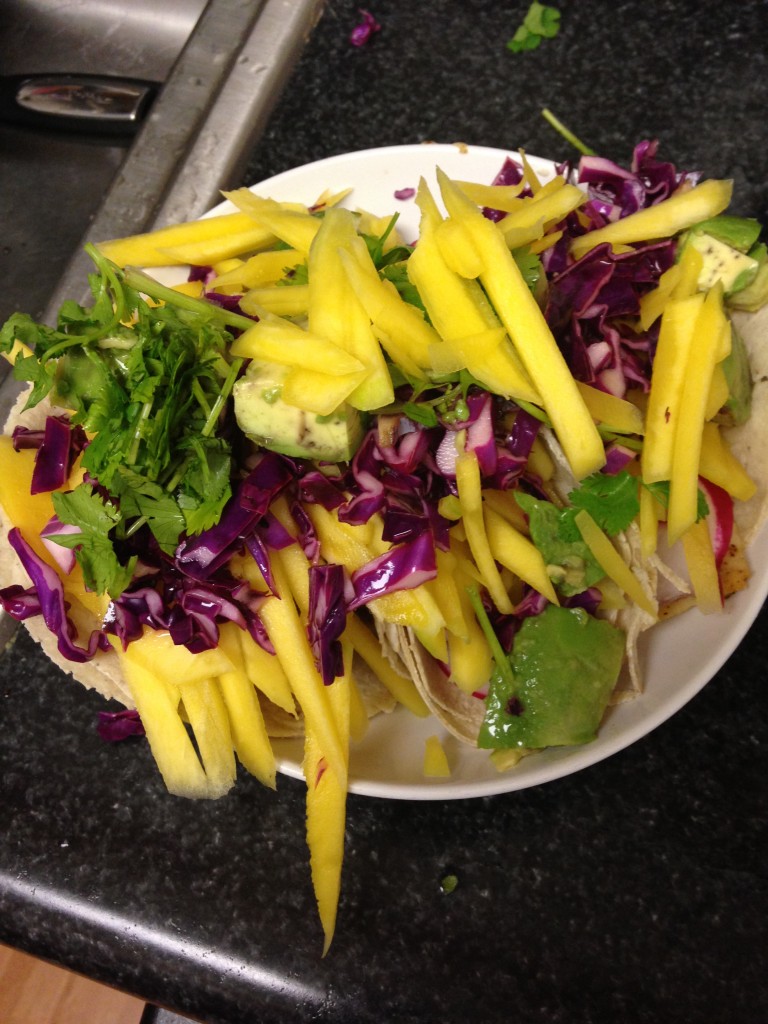 blue apron chili-dusted fish tacos with pickled red cabbage, mango & avocado finished product with toppings piled high