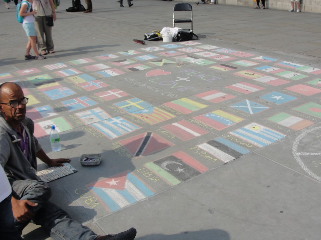 chalk drawings of international flags on plaza at trafalgar square