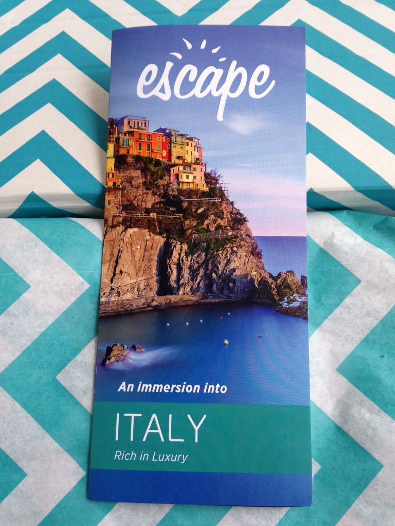 escape monthly december italy box info card against blue and white chevron background