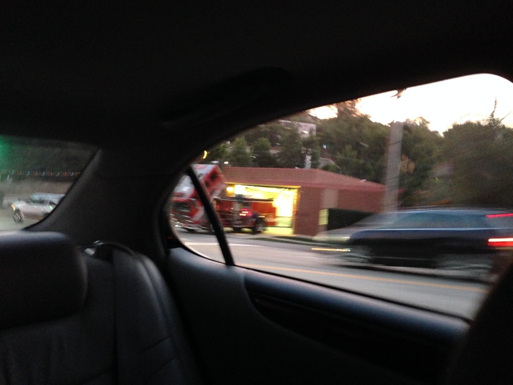 blurry image of firetruck with front part tilted open