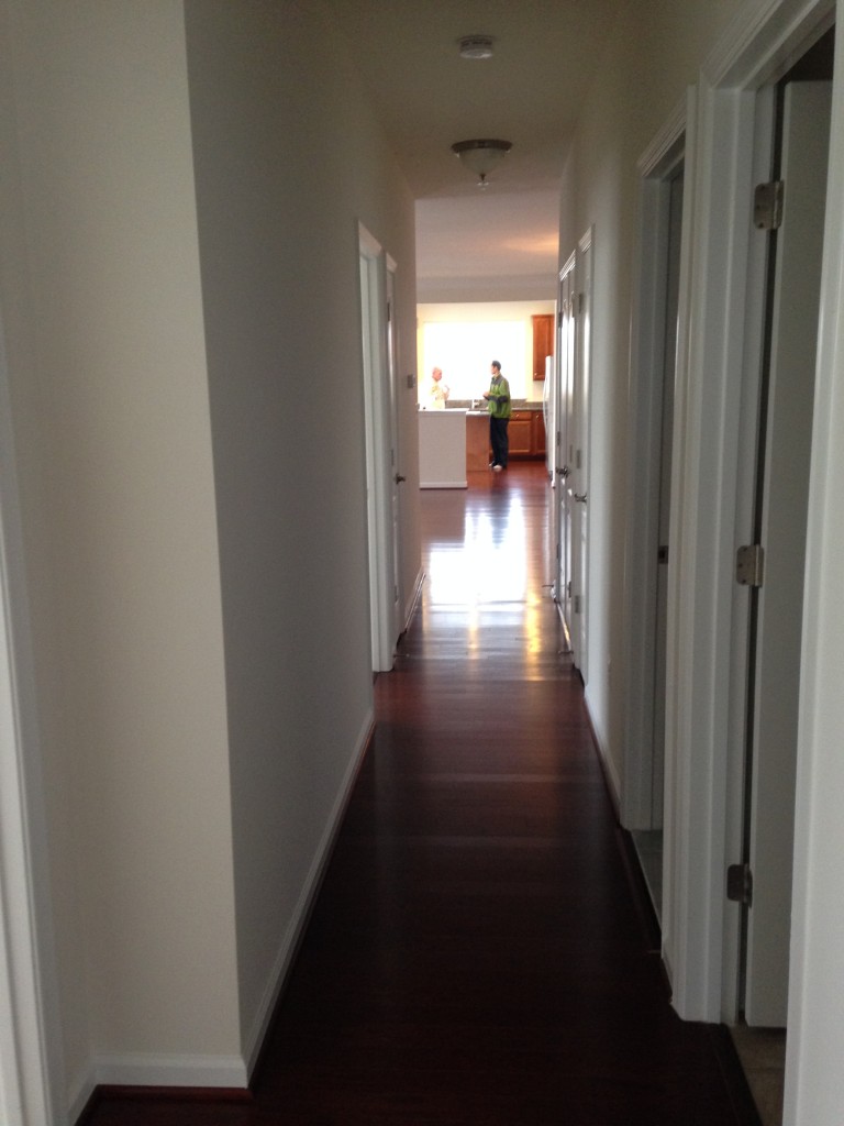 hallway of new condo with hardwood flooring