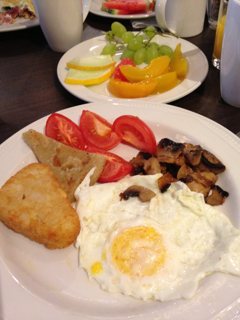 breakfast spread at hilton edinburgh with hash brown, tomatoes, mushrooms, fried egg, and fruit