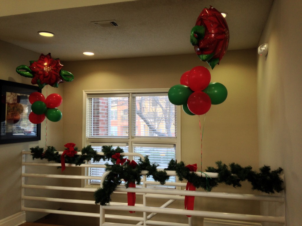 red and green balloons and christmas decorations on railing