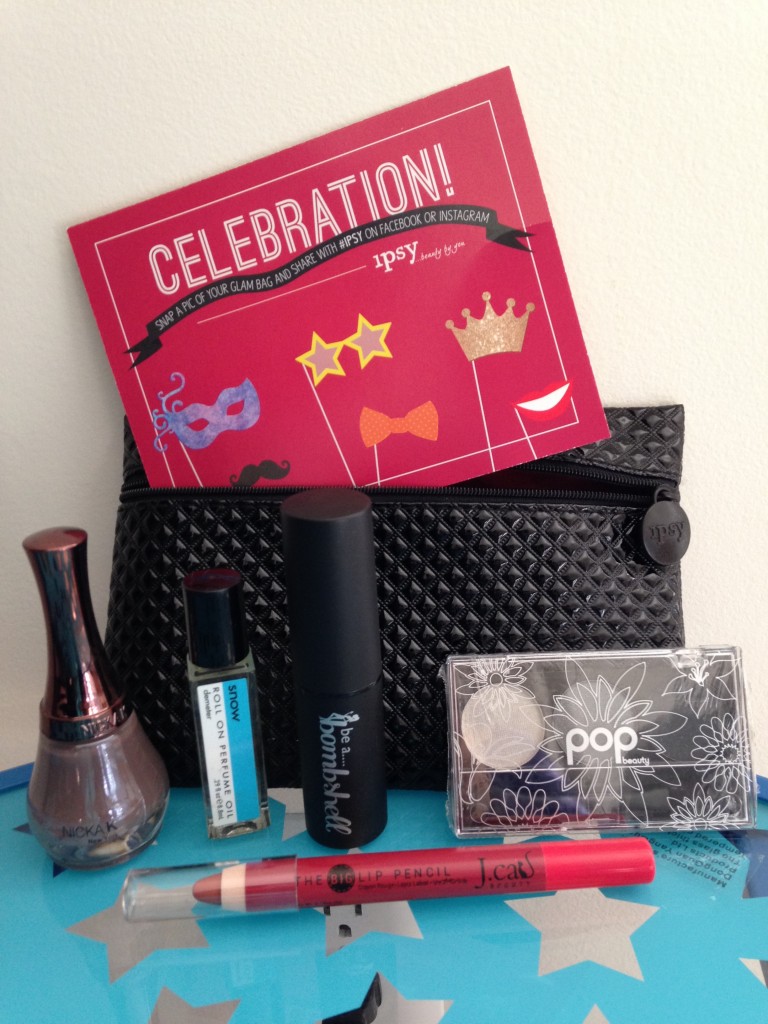 ipsy december 2013 bag items with card including nicka k new york nail color in classic taupe, demeter roll on perfume oil in snow, be a bombshell the one stick in flustered, pop beauty eye shadow trio in smokin' hot, and j.cat beauty big lip pencil in caramel mocha