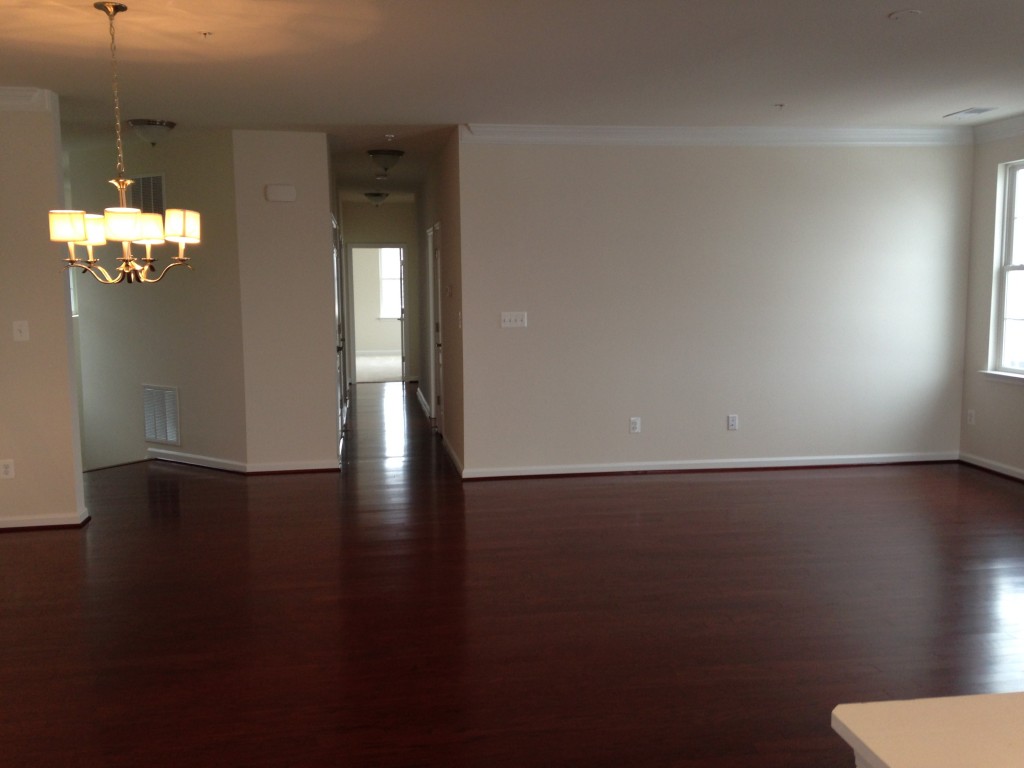 large open space of living and dining room with cherry hardwood floors