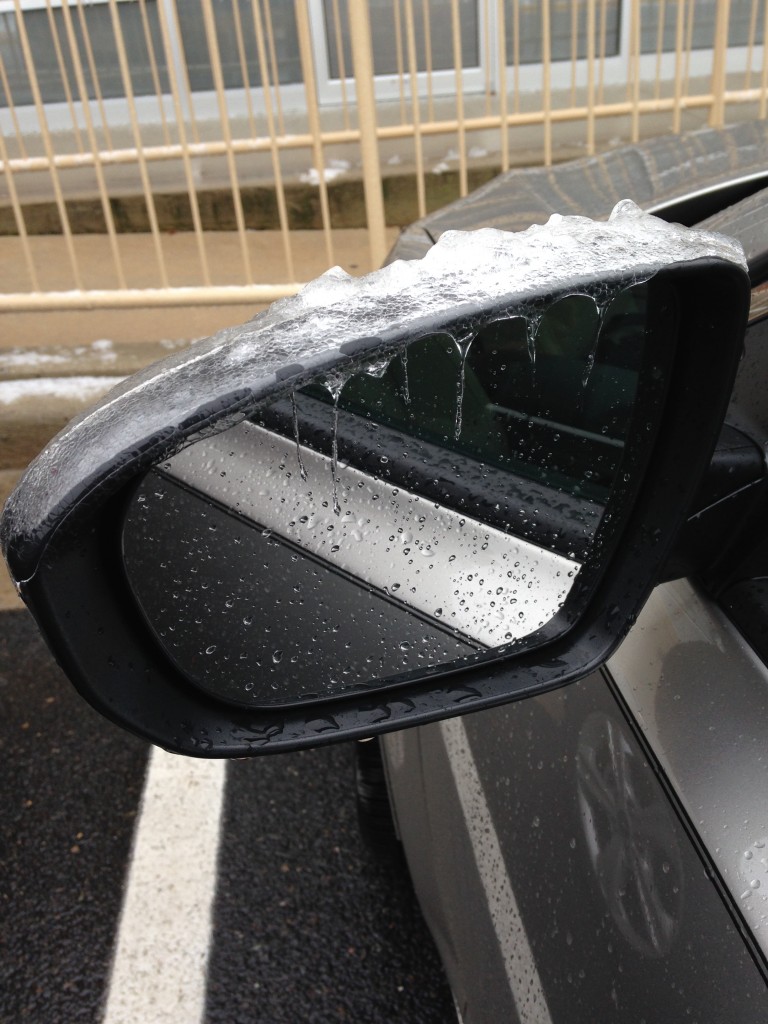 melting icicles on car's mirror