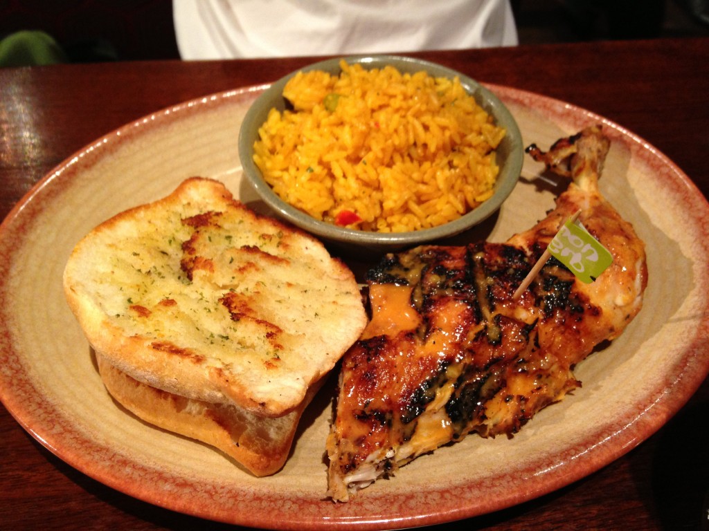 nando's grilled chicken dark meat with sides of rice and garlic bread