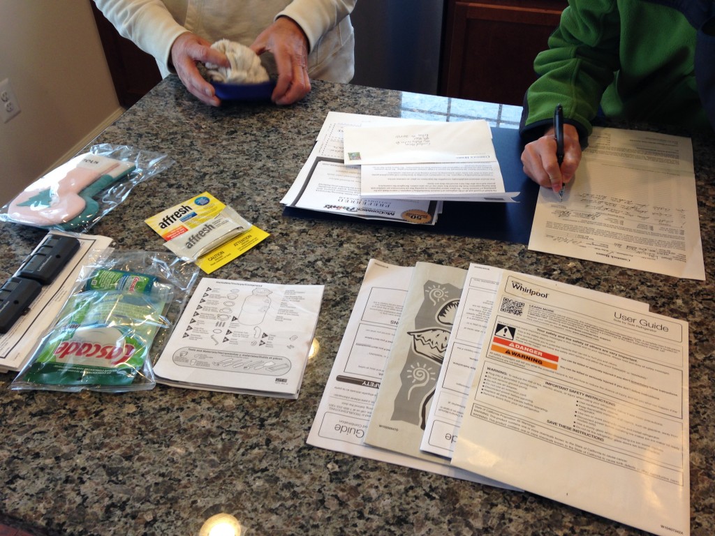 paperwork for new condo with manuals for appliances and other instructions
