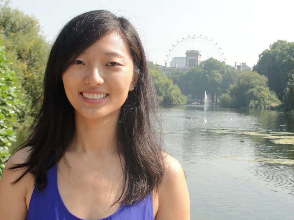girl posing in front of st. james's park lake with view of london eye in background