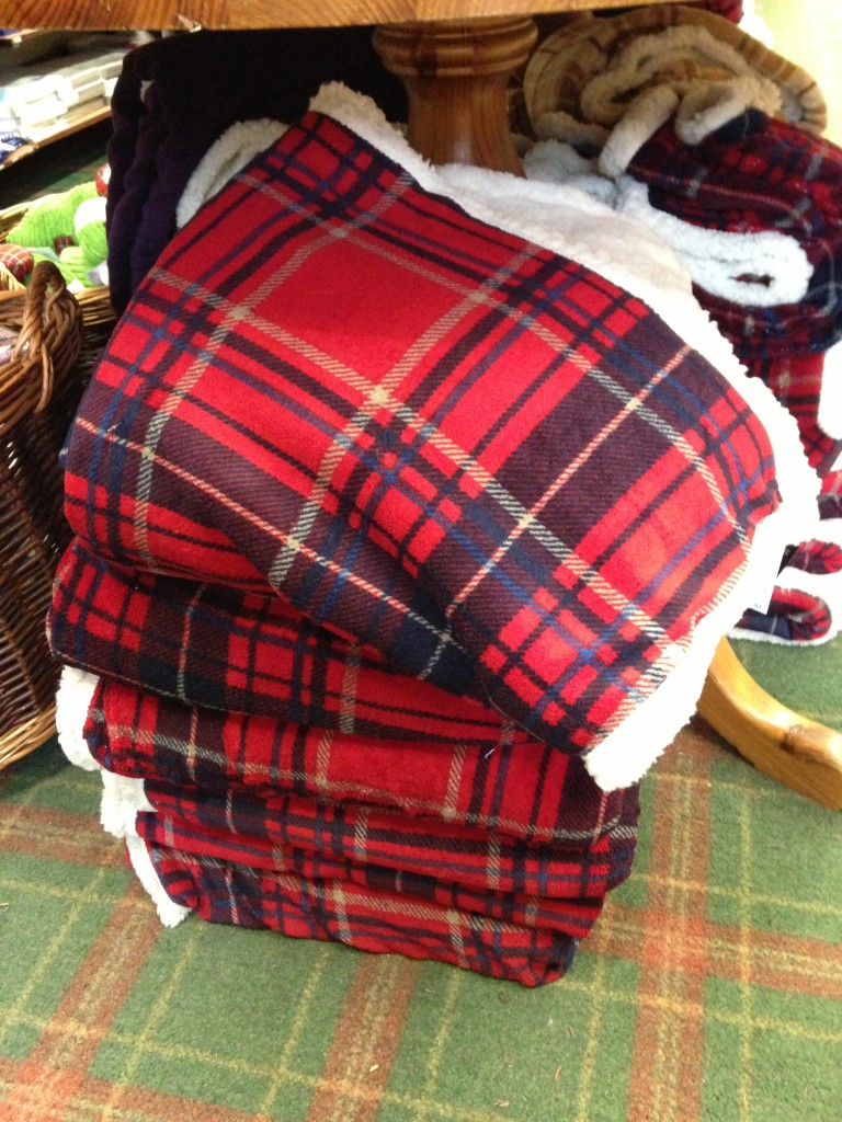 pile of red scottish print sherpa blankets